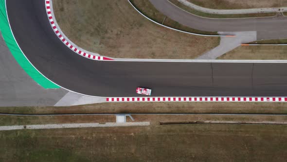 Aerial top down view of Hungaroring race track corner during endurance competition, fast car driving