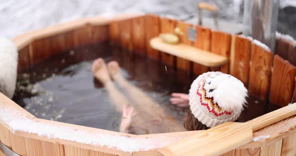 Woman Relaxing in Hot Bath in Winter