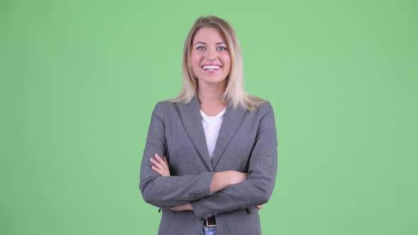 Happy Young Beautiful Blonde Businesswoman Smiling with Arms Crossed