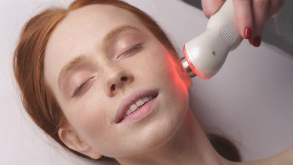 Happy Woman Receives a Hardware Phonophoresis Procedure From a Cosmetologist in a Spa Salon