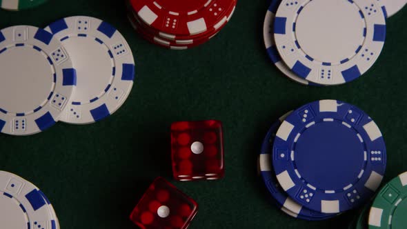 Rotating shot of poker cards and poker chips on a green felt surface - POKER 028