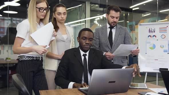 African American Businessman which Showing to His Considerate Purposeful Male and Female