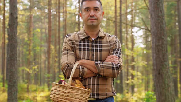 Man with Mushrooms Showing Thumbs Up in Forest