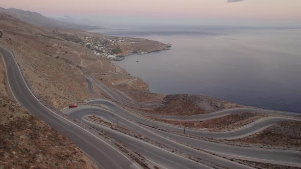 Aerial drone 4K footage of a curved rocky road. Motorway through mountains next to a precipice