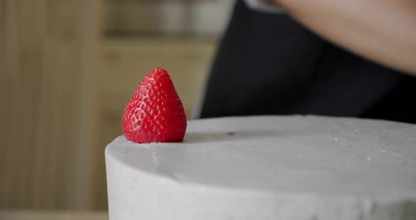 Woman Cooking and Decoration of Cake with Cream Decorating Red Strawberry