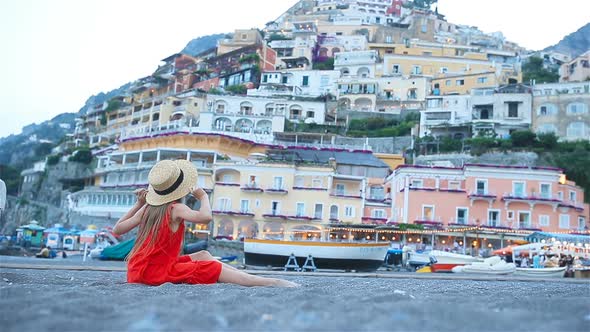 Adorable Little Girl on Warm and Sunny Summer Day in Positano Town in Italy