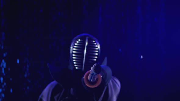 Japanese Kendo. Blurred View of a Kendo Fighter Stands in Armor and with a Bamboo Sword Against the