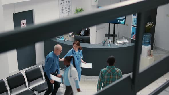 Receptionist Working in Hospital Waiting Area and Offering Support