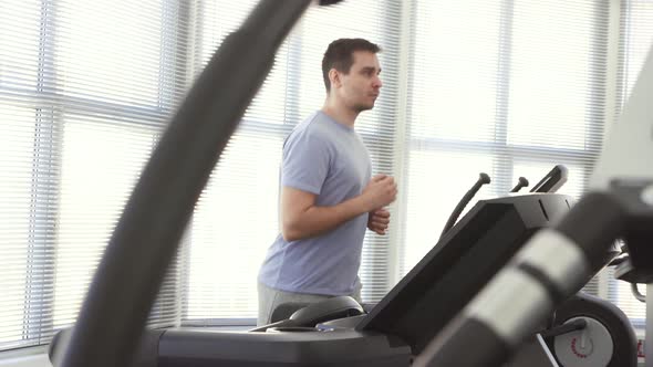 Portrait of a Man Over 30 on a Running Simulator