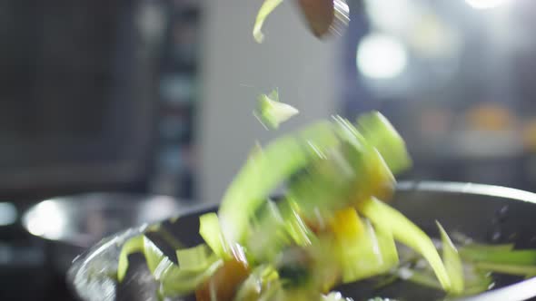 Tossing Veggies on Skillet