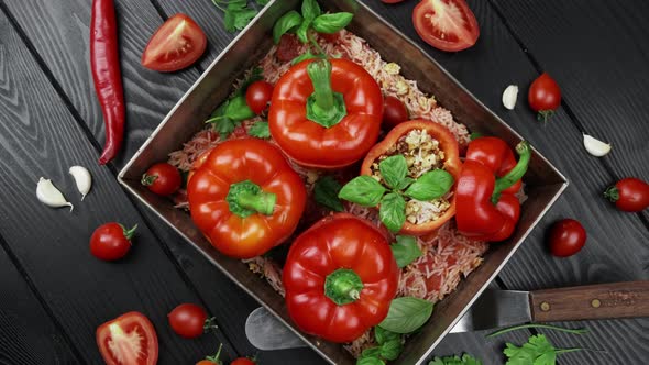 Stuffed Red Peppers with Rice Onion on Black Stone Background