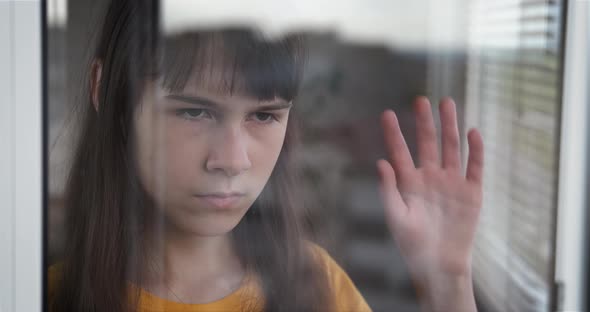 Teen Look Outdoor on Window