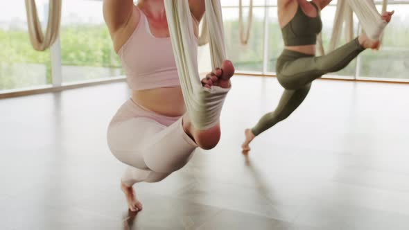 Women Stretch Legs With Aerial Hammocks