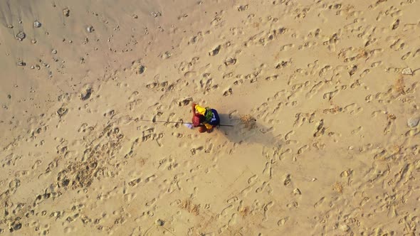 Single male happy and fishing on tranquil seashore beach holiday by aqua blue sea with bright sand b