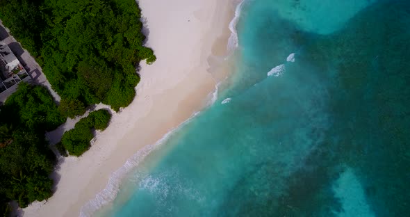 Wide angle above abstract view of a sandy white paradise beach and aqua blue water background in col