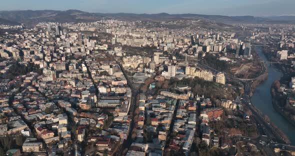 Flying over Shota Rustaveli street in the center of city. Morning aerial cityscape of Tbilisi