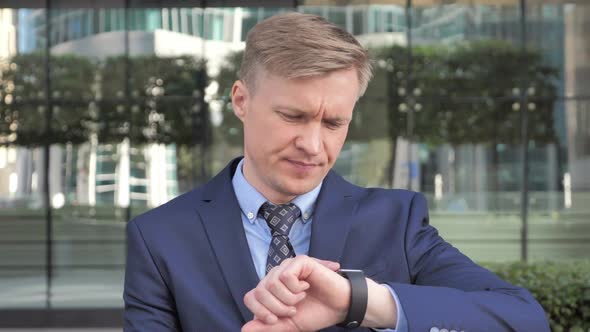 Businessman Waiting While Sitting Outside Office