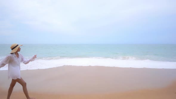 Asian woman enjoy around beautiful beach sea ocean