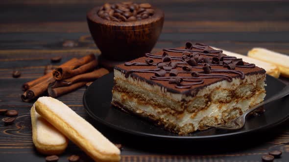 Portion of Traditional Italian Tiramisu Dessert and Pieces of Chocolate Bar