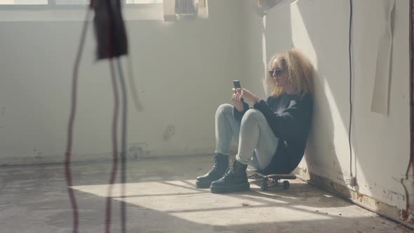 Fashionable young woman in an abandoned warehouse