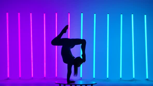 Young Woman Gymnast Doing a Handstand