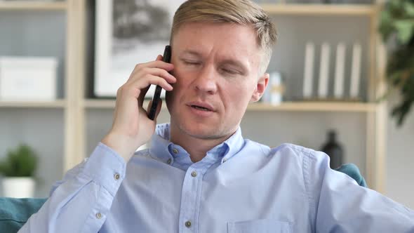 Portrait of Businessman Talking on Phone