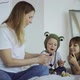 adorable mother and her children, daughter and little son play toys on fingers - VideoHive Item for Sale