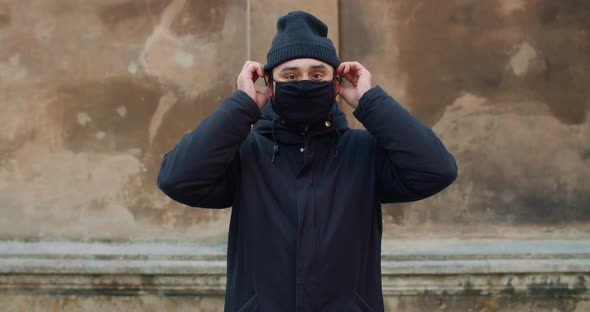 Bearded Man Wearing Black Cotton Protective Mask. Portrait of Guy Standing at Street and Looking To