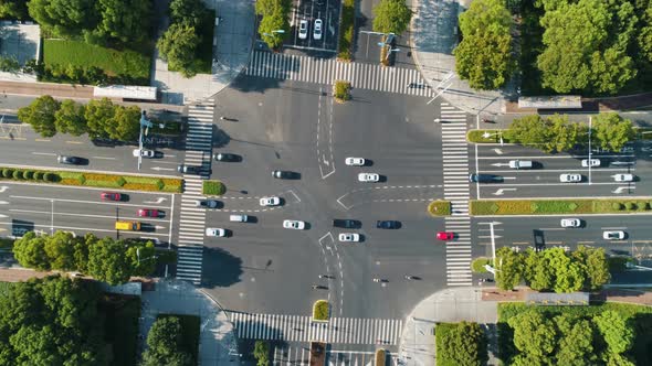 Aerial Top Down View of an Intersection Crossroads with Traffic Moving Cars of Different Colors and