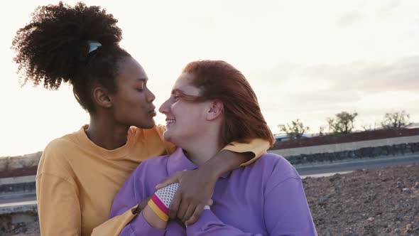 Happy women gay couple having tender moments outdoor - Lgbt and love relationship concept