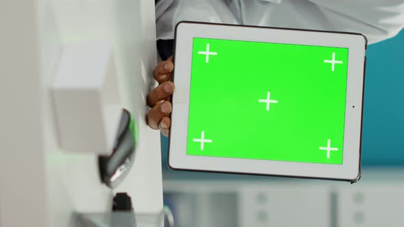 Vertical Video Doctor Holding Digital Tablet with Greenscreen Background