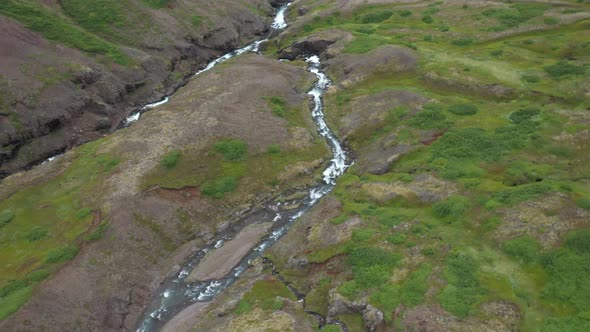 Waterfalls in Iceland that are stacked up with drone video moving over.