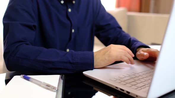 Male Freelancer Working on Laptop at Homeoffice