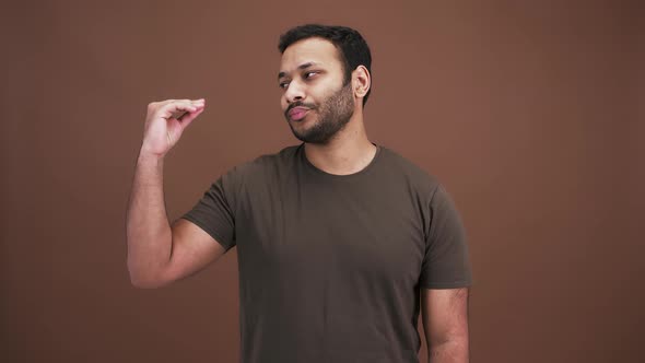 Studio Portrait of Boring Indian Man Making Blah Blah Gesture with His Hand Expressing Disbelief