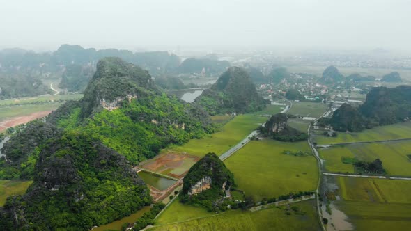 Aerial: North Vietnam karst landscape, drone view of Ninh Binh canyons and pinnacles
