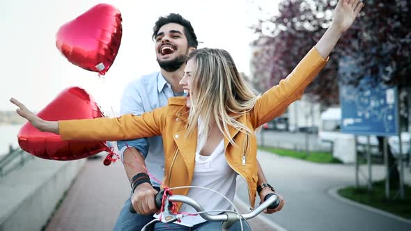 Young Beautiful Couple Dating While Riding Bicycles in the City