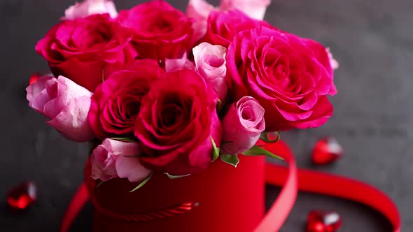 Pink Roses Bouquet Packed in Red Box and Placed on Black Stone Background