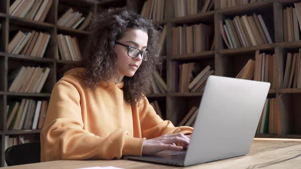 Serious Hispanic Teen Girl College Student Using Laptop Study Work Online