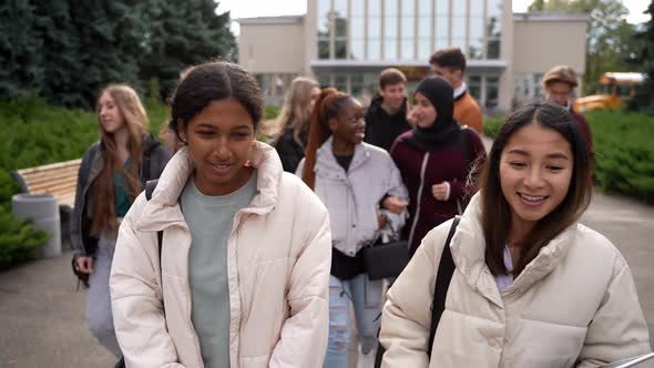 Joyful Multiracial Students Walking in School Park