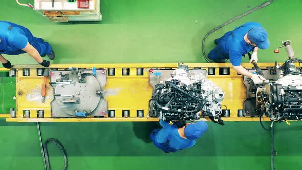 Workers Are Assembling Car's Inner Parts in a Top View