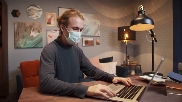 Mixed Race American Freelancer Man Wearing Medical Protective Mask Communicating with Client Via