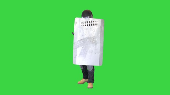 Soldier in Full Uniform Covering with Protective Shield Moving Forward on a Green Screen Chroma Key