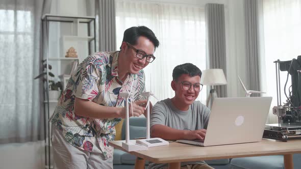 Father Teach His Son Using Laptop Computer Programming Electric Wind Turbine Model