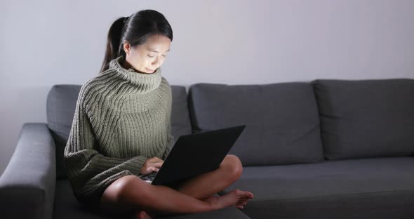 Woman working on laptop computer at night