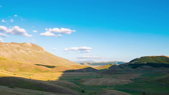 Time lapse: sunset over Castelluccio di Norcia highlands, Italy. The village perched on hill top ove