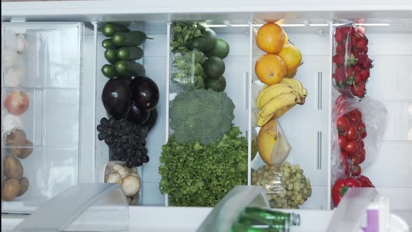 Opening a Fridge or Refrigerator in Kitchen Home CloseUp