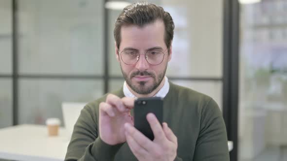Portrait of Young Businessman Using Smartphone
