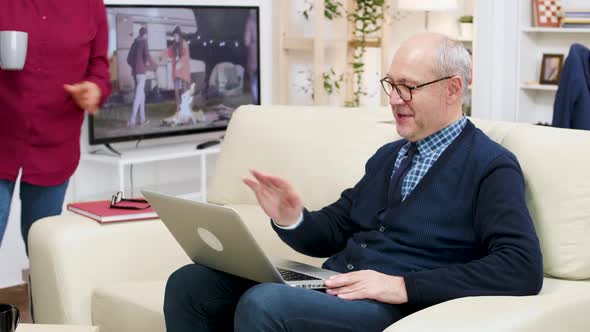 Happy Old Couple Sitting on Sofa During a Video Call