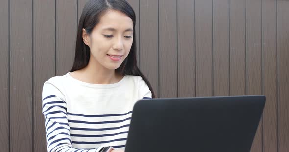 Woman Using Notebook Computer at Outdoor