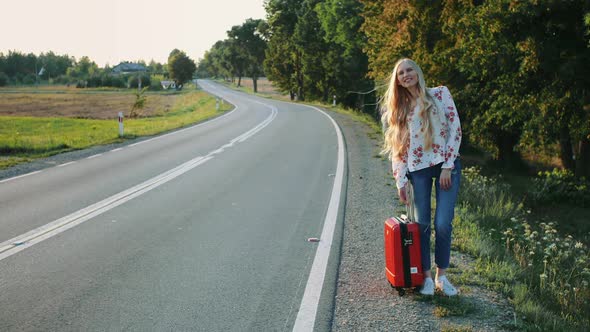 Young Lady Hitchhiking on Countryside Road